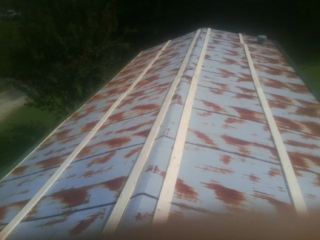 Rusted metal roof panels with new wood purlins before replacement — Storm Damage Roof Repair in Thousand Oaks by Roofing Brothers