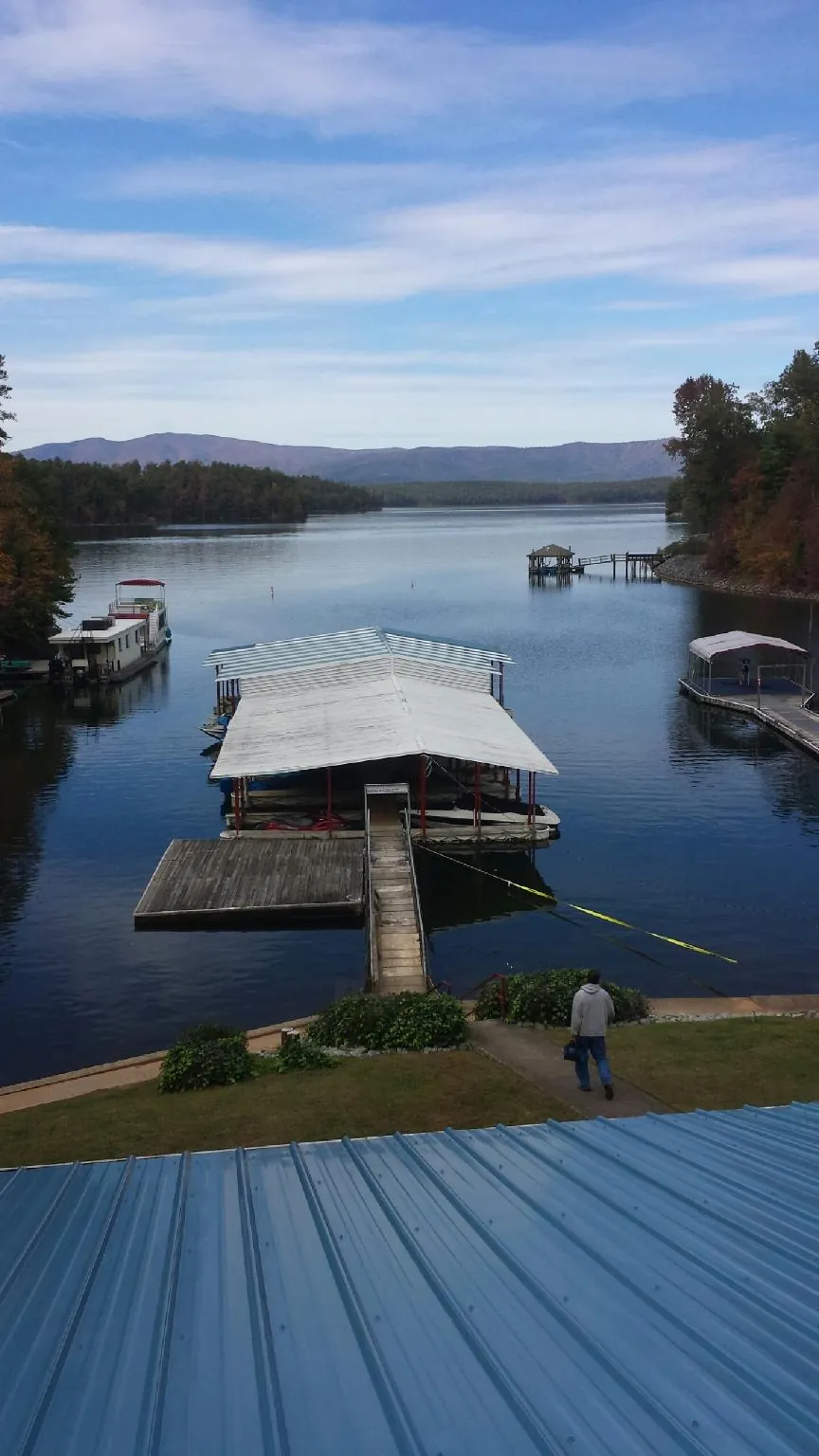 View across a lake from a newly installed blue metal roof in Thousand Oaks