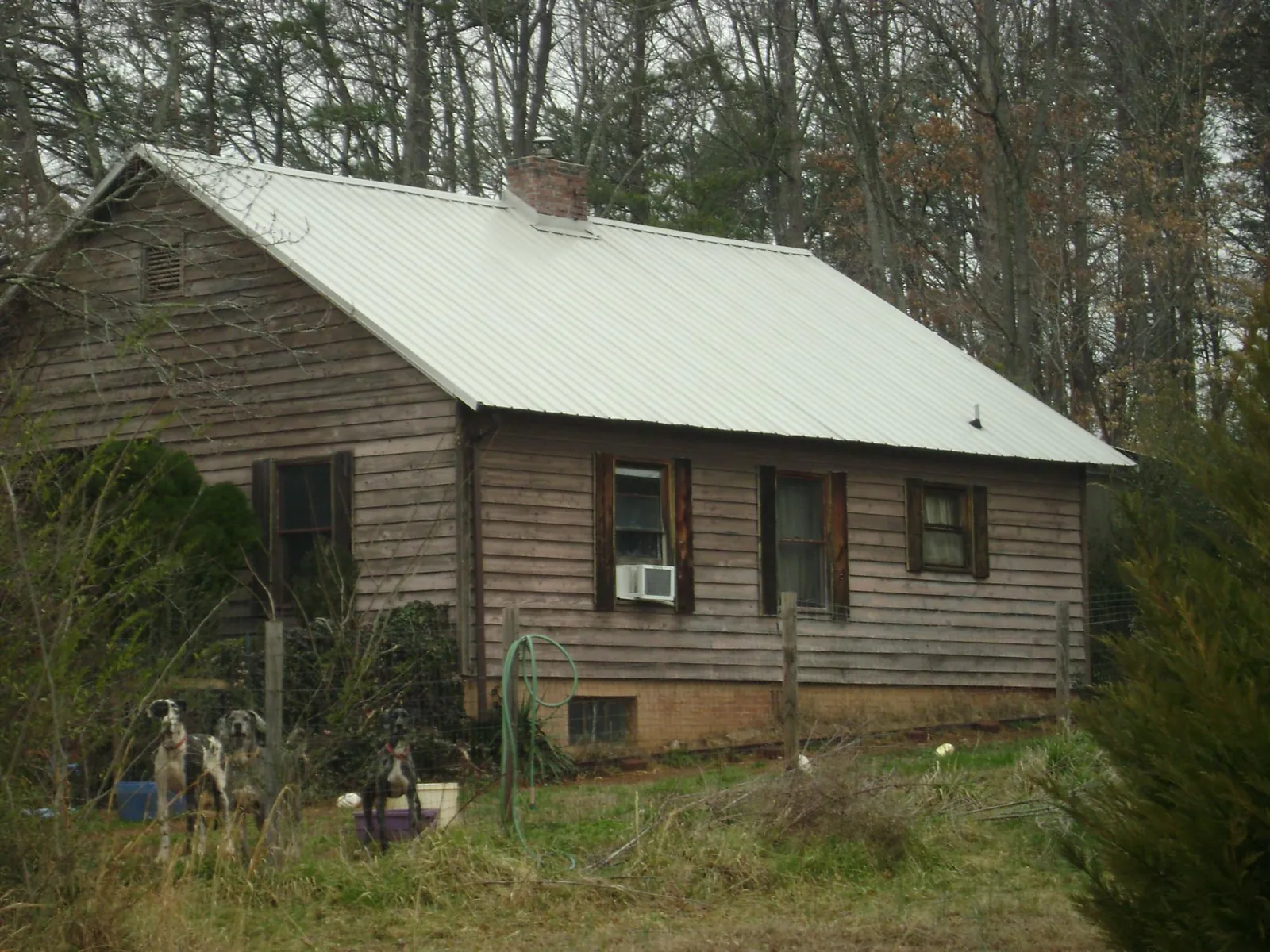 White metal roof on an old wood sided farmhouse, from a Metal Roof Installation job in Thousand Oaks